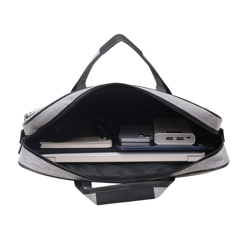 Laptop carry bag open, holding a laptop, tablet, power bank and notebook